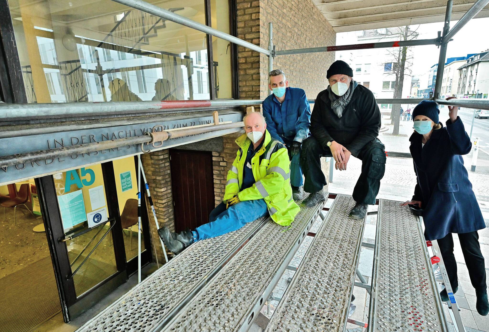 62 Jahre nach der Anbringung des Originals wurde jetzt die Replik an gleicher Stelle am Rathaus befestigt: (v.l.)  Jürgen Berbalk und Roland Sandmann von der Firma Butzon &amp; Bercken, Künstler Sven Rünger und die Kulturbeauftragte Dr. Gabriele König.Foto: Stadt Krefeld, Bischof