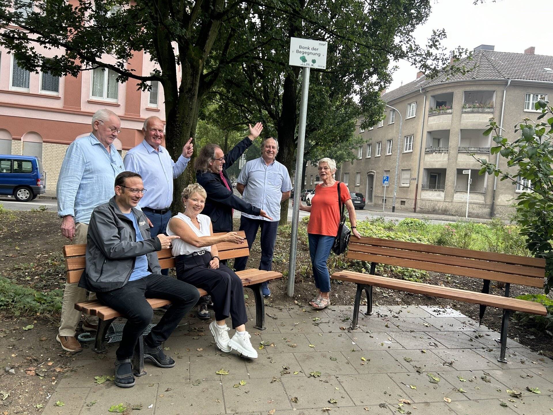 Laden dazu ein, auf der Bank der Begegnung Platz zu nehmen: Jan Biehl, mags-Bereichsleitung Grün, Baum, Forst und Monika Bernhardt (vorne) sowie Hartmut Wellssow, Herbert Hoffacker, Volker Lüttge, mags-Projektkoordinator, Norbert Jansen und Brigitte Brouns. 