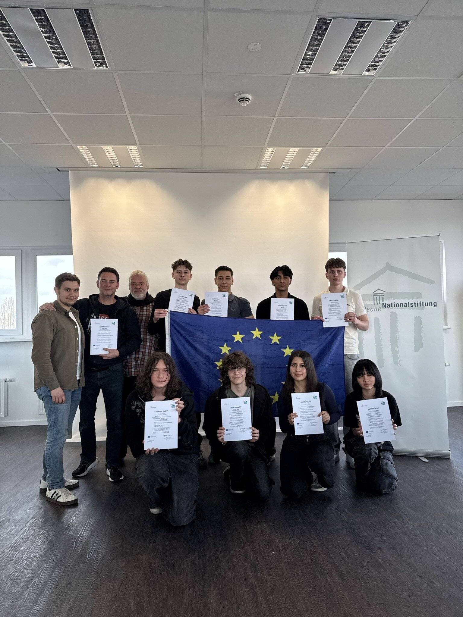 Fernsehautor Axel Sommer, Lehrer Reinhard Bitter und SchulBrücken-Moderator Marvin Kamphausen (obere reihe v.l.) sind stolz auf die erfolgreichen Teilnehmer des Hugo-Junkers-Gymnasiums.   