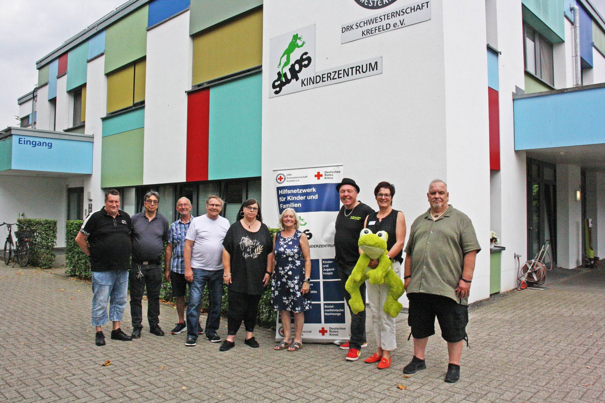  DJ Ludwig Schmitz (mit Hut) und seine „kölschen Fründe“ brachten eine Spende aus Vorst für das Kinder- und Jugendhospiz zu Anja Claus (mit Frosch im Arm), der Leiterin des stups Kinderzentrums. 