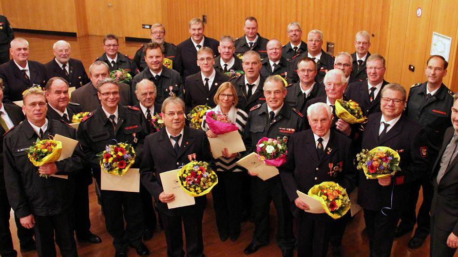 Bürgermeister Christoph Fleischhauer und Christoph Rudolph, Leiter der Feuerwehr, ehrten am Freitag, 2. November, im Kulturzentrum Rheinkamp verdiente „Blauröcke“.