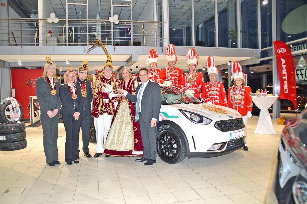  Die Minister Siggi, Nicole und Jan, das Oppumer Prinzenpaar Sebastian I. und Jessica I., derKia-Markenverantwortliche und -Verkaufsleiter des Autohaus Lauff in Moers und Geldern, DominikSons (von links), sowie der 2. Kommandant Heinz Walter (3.von rechts) bei der Schlüsselübergabeim Autohaus Lauff.  
