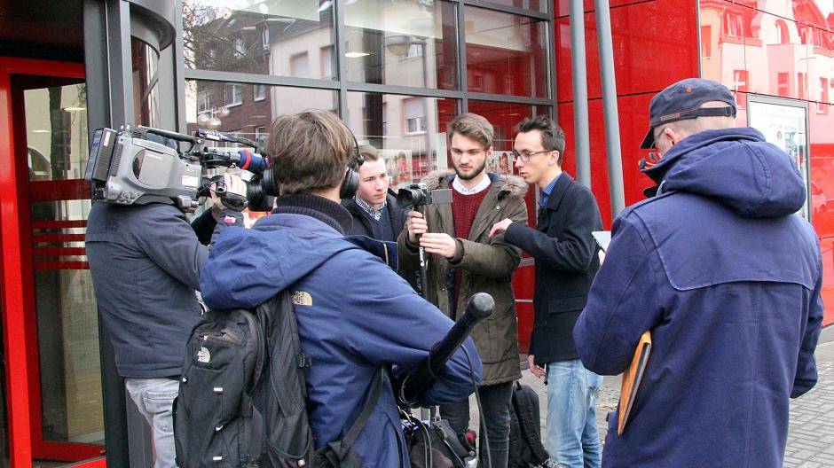 Die Schüler Bastian Simon, Jonathan Endrigkeit und Niklas Thum (v.l.n.r.) stellen eine Szene aus ihrem Knete-für-die-Fete-Video nach. Dabei werden sie vom WDR-Fernsehteam gefilmt. Der Beitrag für die Lokalzeit Duisburg ist ab sofort in der WDR-Mediathek zu sehen. 