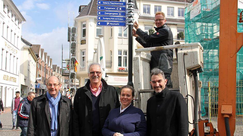  Freuen sich über den Start der neuen Wegweiser in der Innenstadt: Stefan Oppermann, Achim Reps, Andrea Käfer und Thorsten Kamp (v.l.). Ralf Maas (o.) von der Firma Haubruck hat die ersten Schilder angebracht. 
