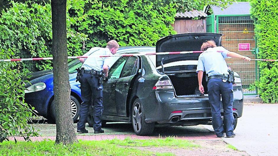 Polizisten inspizieren das zurückgelassene Fahrzeug der verdächtigen Männer auf einem Stellplatz an der Straße Am Anger.
