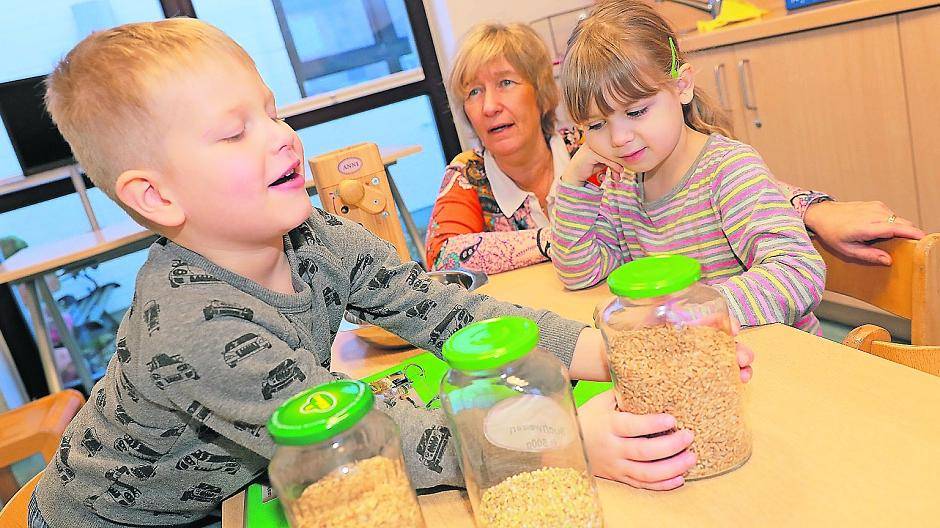 Dominik und Kassandra brauchen nur wenig Hilfe von Marion Westphalen. Dinkelflocken quetschen mit der Flockenpresse ist dabei wie Fitnesstraining für die Armmuckis.