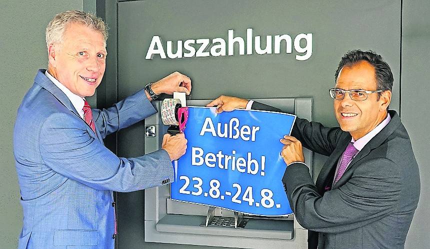  Jürgen Cleven (links) und Michael Willemse informieren ihre Kundschaft: Die Volksbak Viersen stellt das IT-System um. Betroffen sind auch die Geldautomaten. 