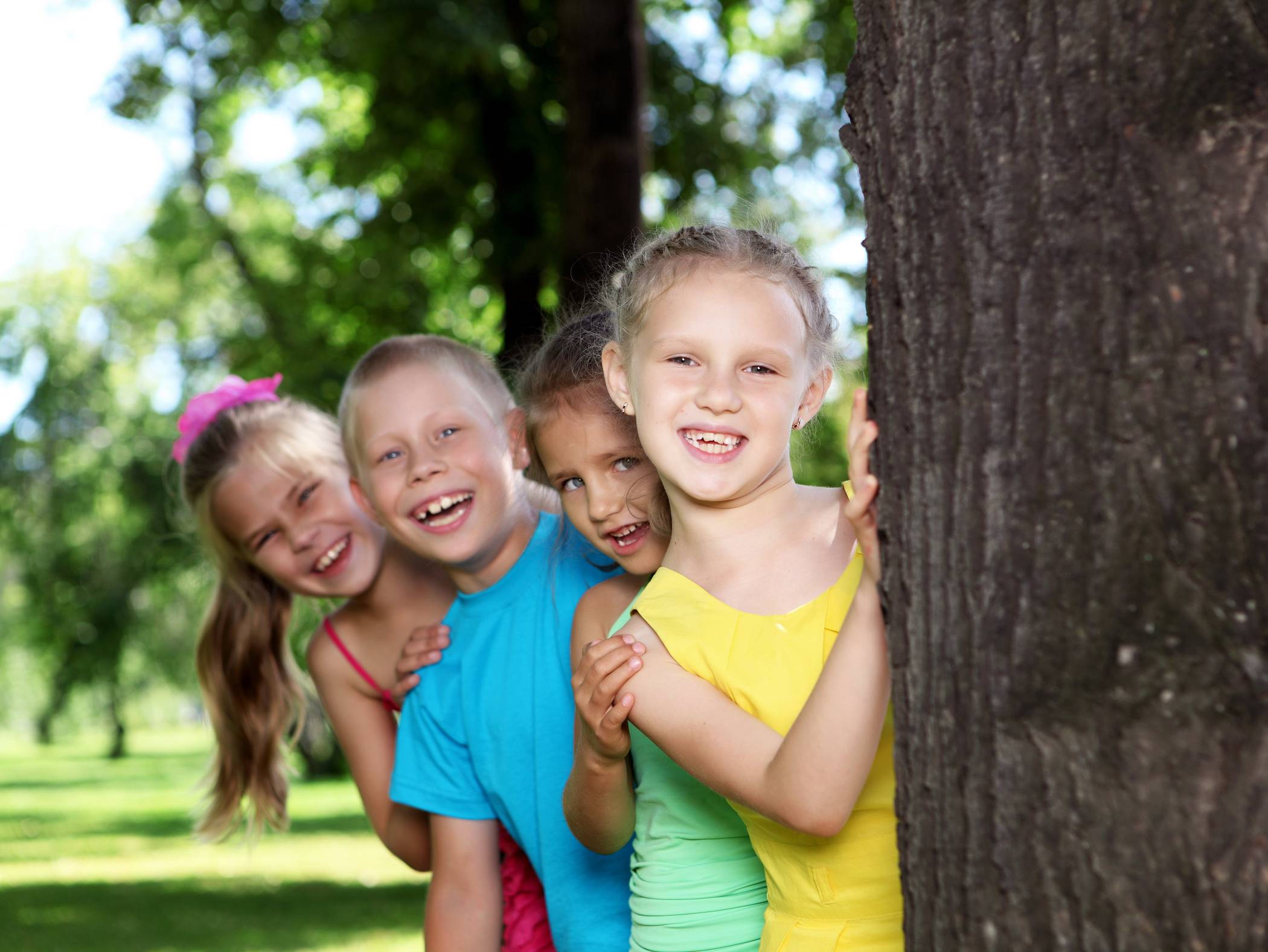  Happy active children playing in the summer park 